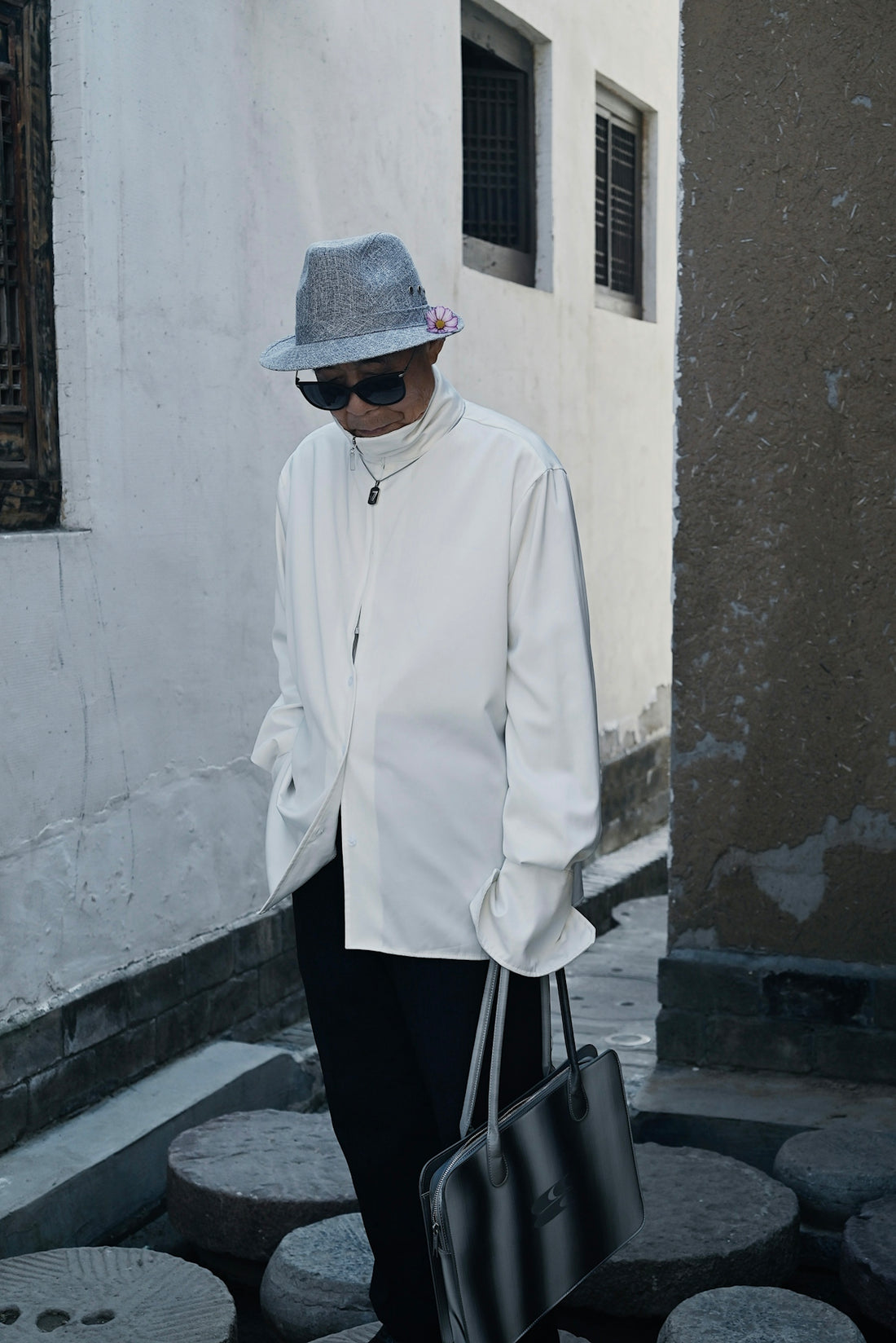 a man wearing a hat and sunglasses