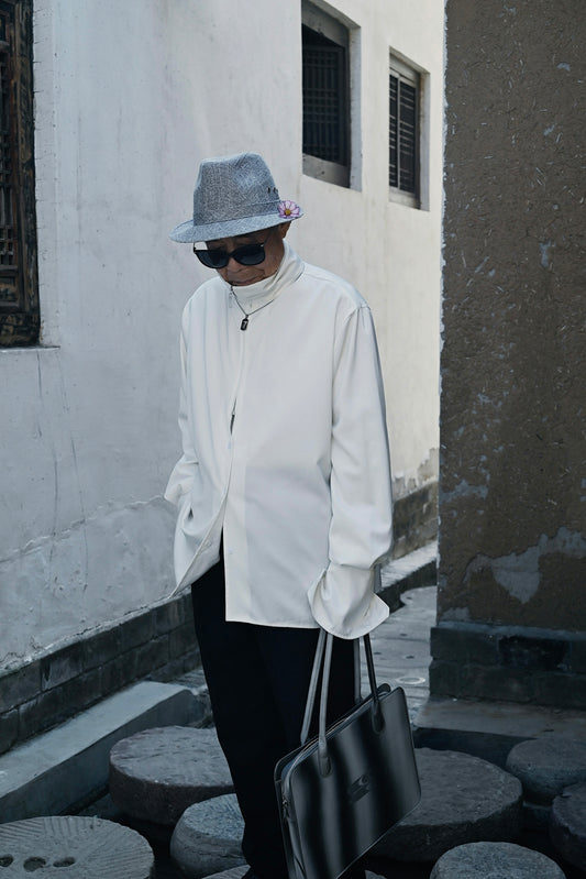 a man wearing a hat and sunglasses