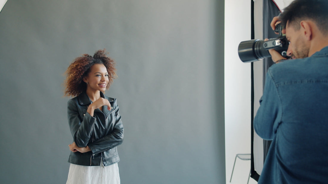 Model posing for photographer in studio setting